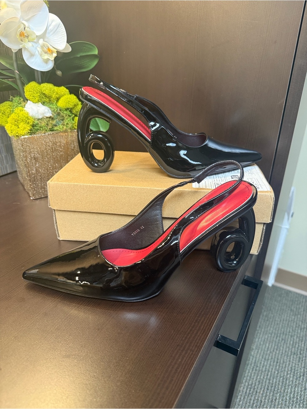 Patent Black Slingback Pumps with Red Insole and Sculptural Heel.